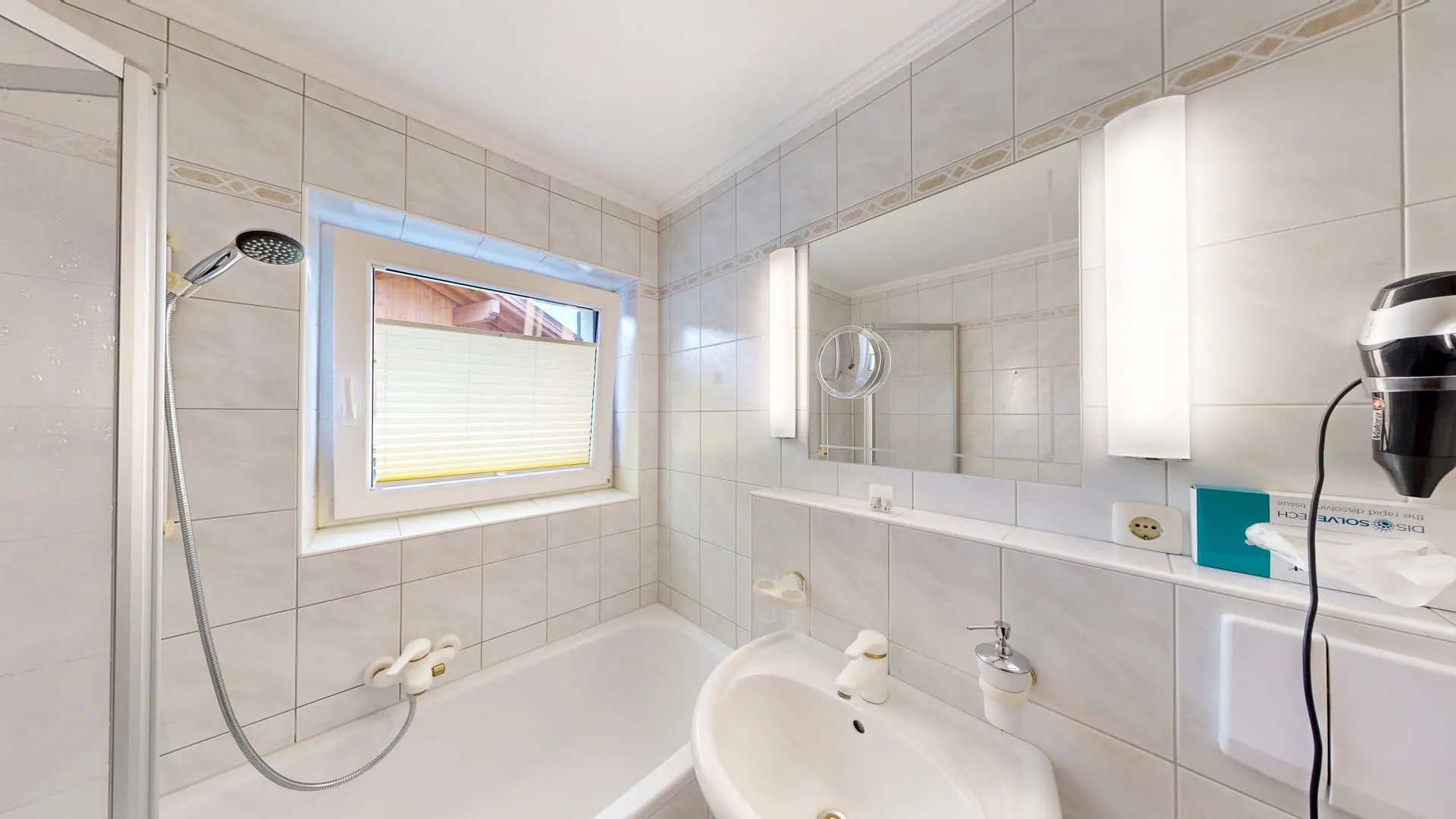 Badezimmer mit Dusche, Badewanne, Waschbecken und Fenster